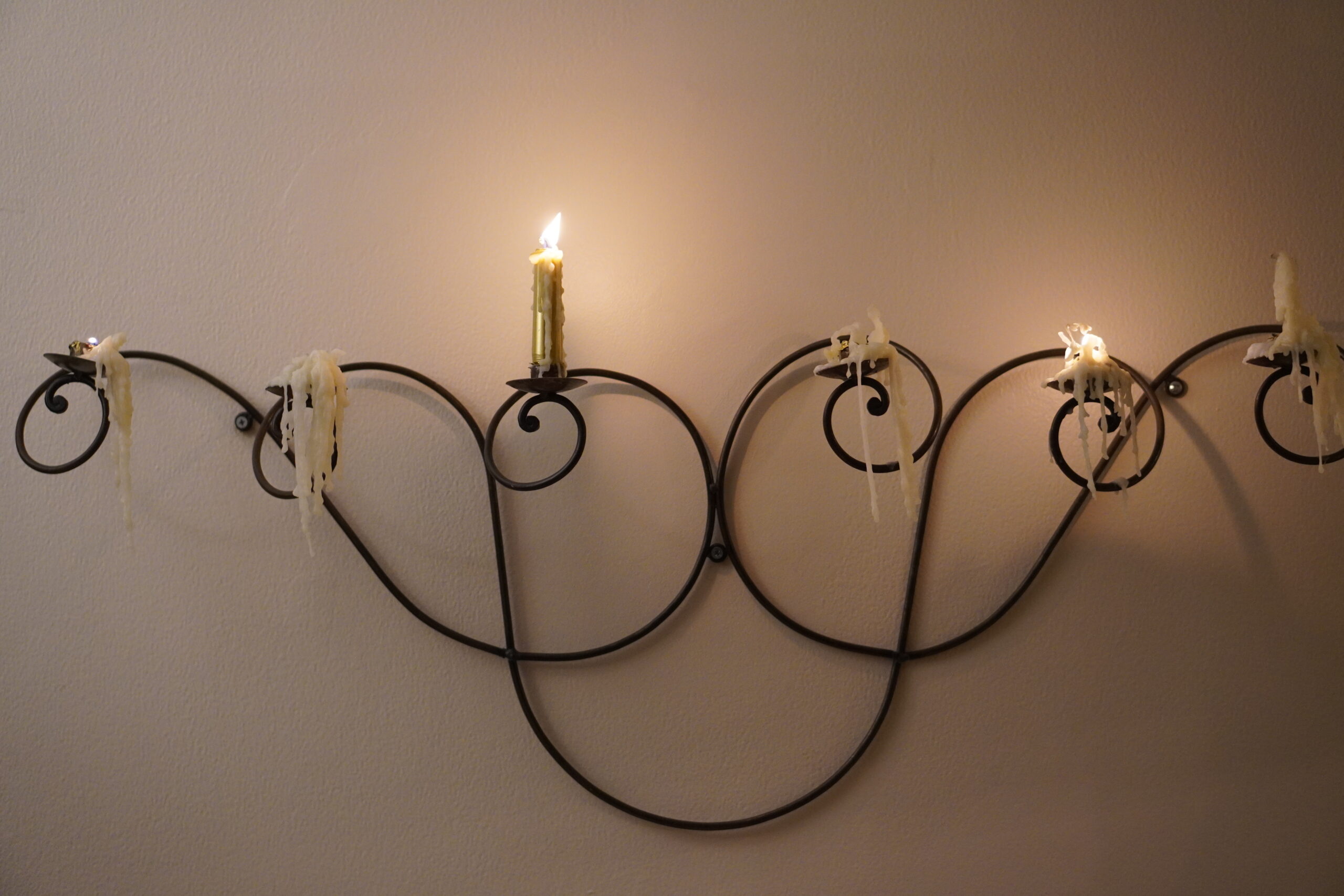 Dripping-Wax-Candles-on-wall-candelabra-