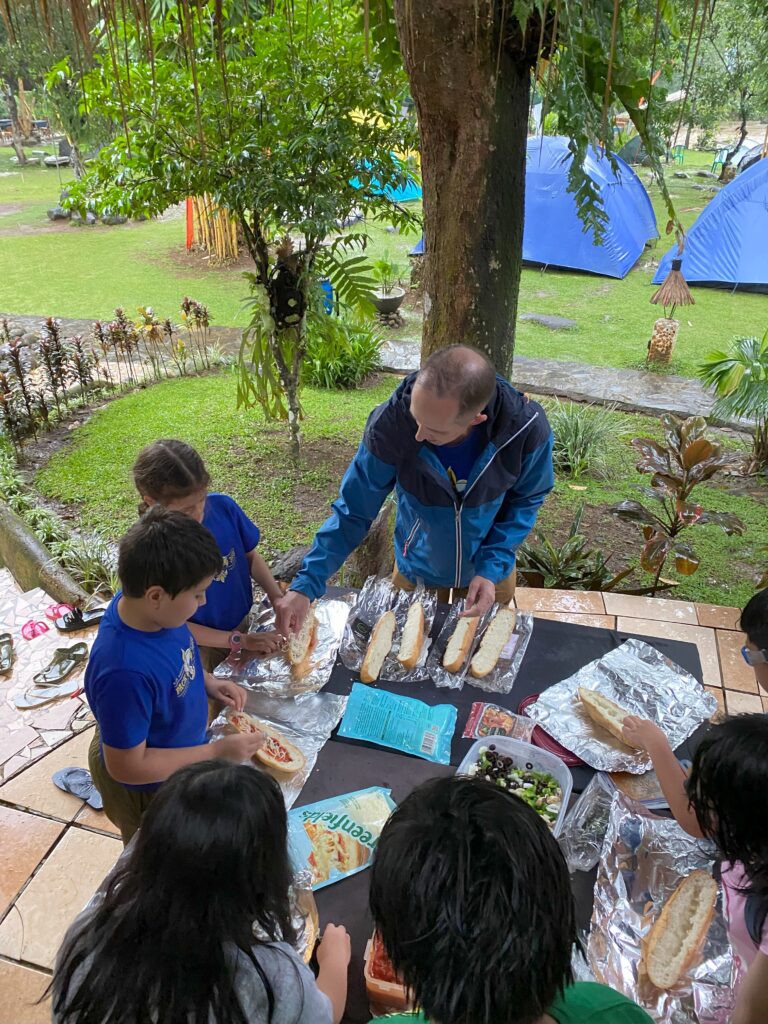 Scouts making pizza bread for dinner